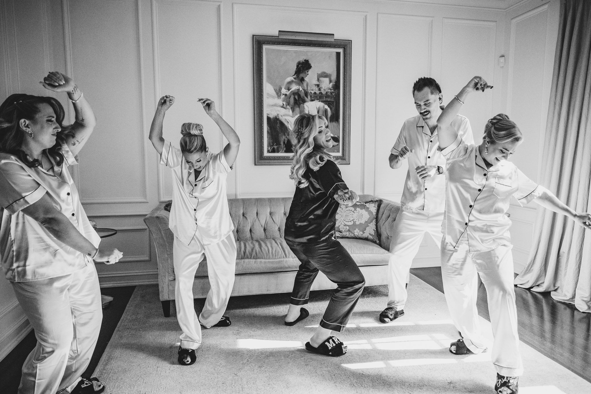 Fun dance sequence showing wedding party members performing choreographed moves in a bright room.