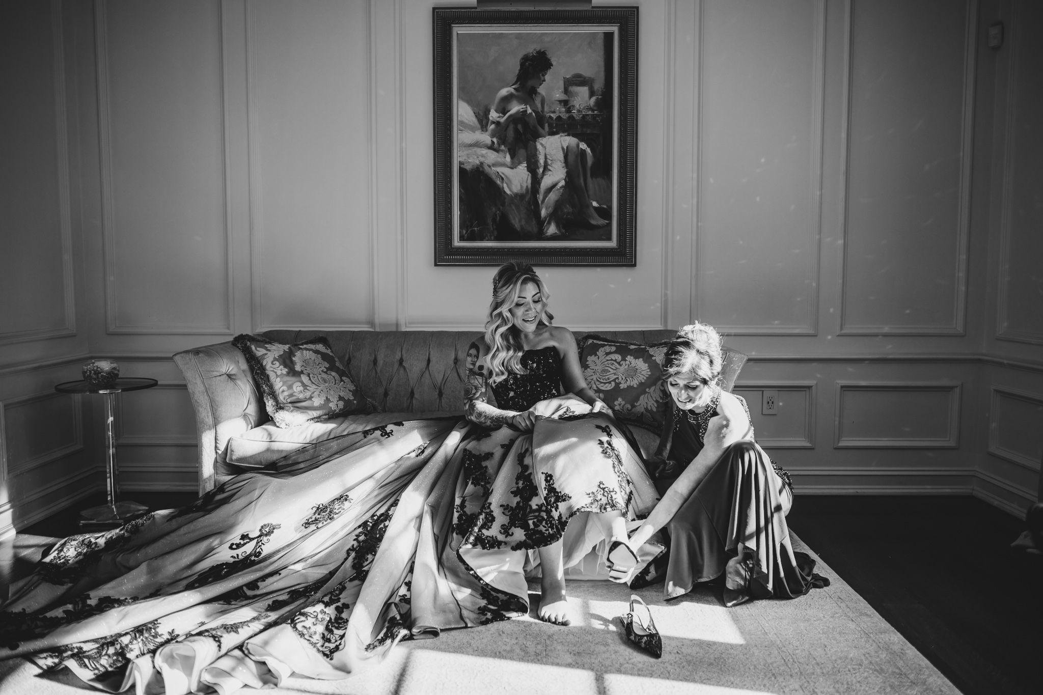 Artistic black and white shots of wedding party relaxing in an elegant interior setting.