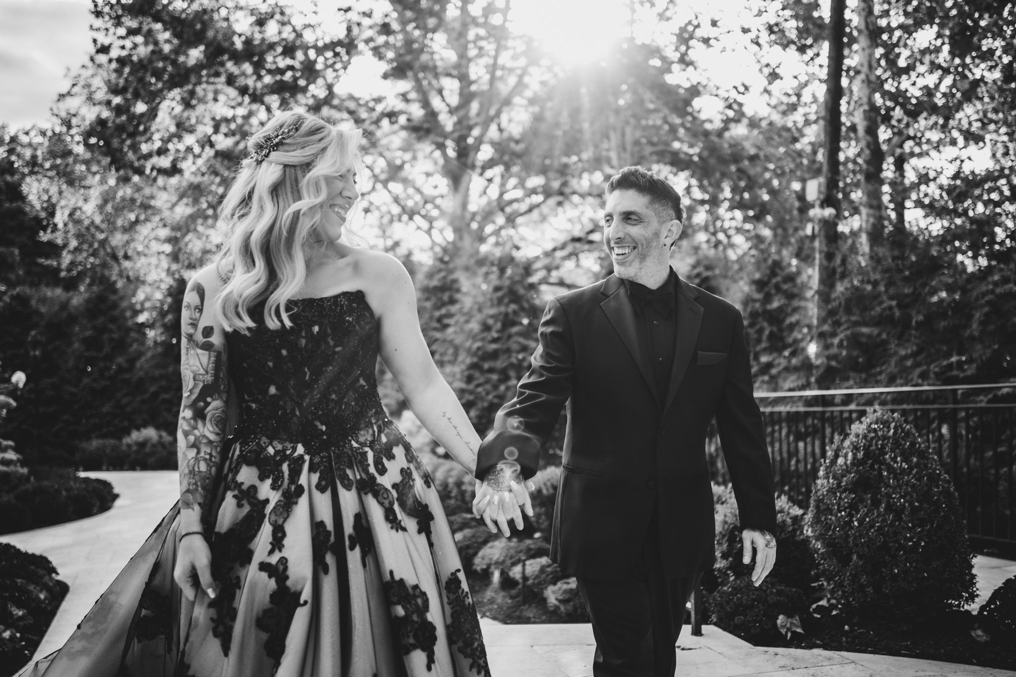 Sunlit outdoor portrait session with couple among trees and natural lighting.