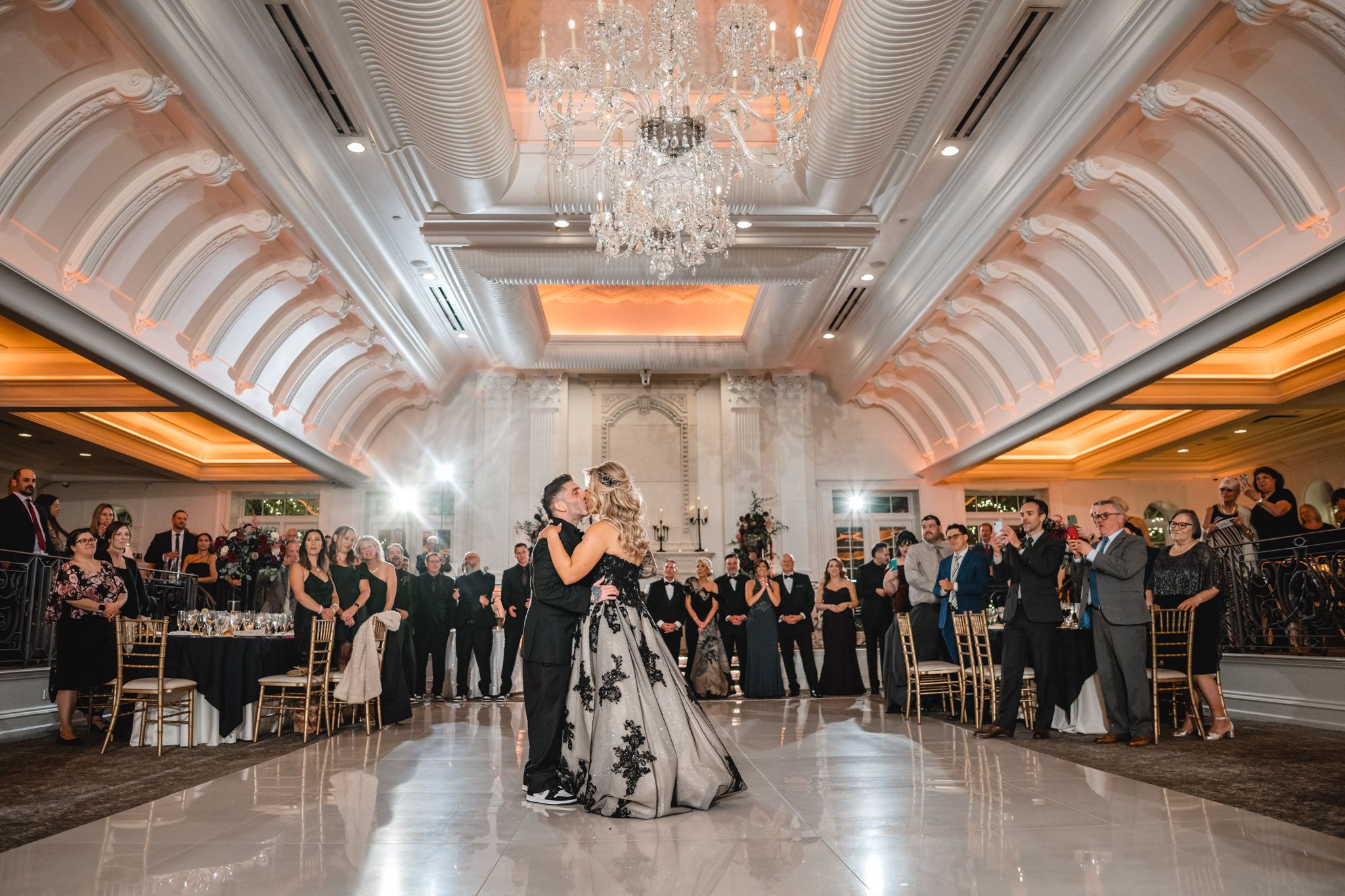 Large ballroom filled with guests during an elegant wedding reception.