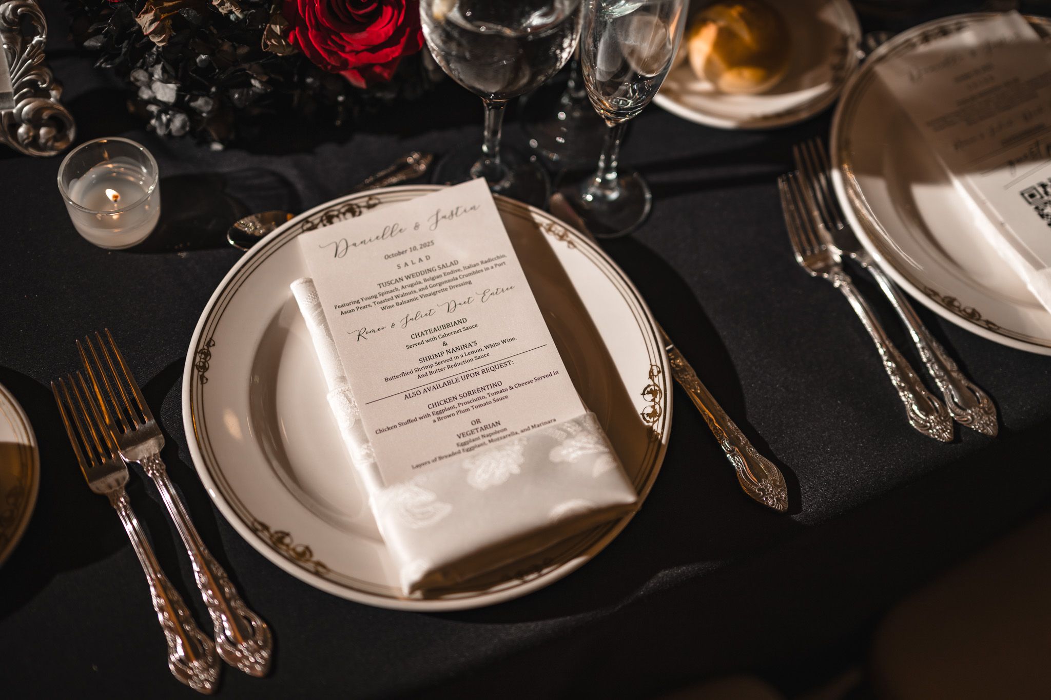 Elegant table settings with menus and glassware at a formal event venue.