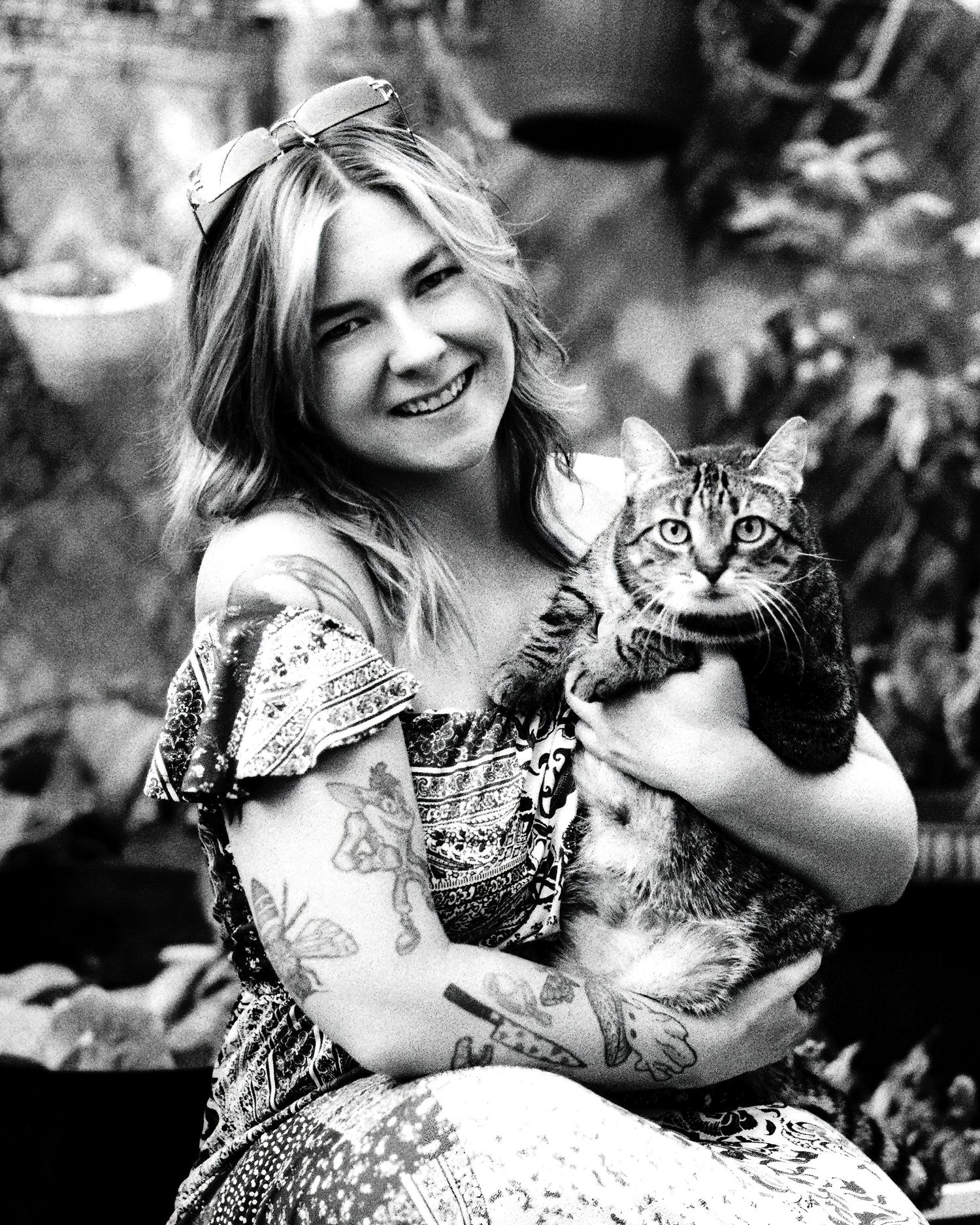 David G Holt Photography - Black and white portraits showing joyful moments with a cat in an outdoor garden setting.