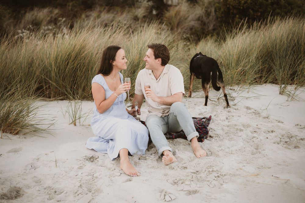 Couples session with their dog at Big Roaring Beach in Southern Tasmania, captured by elopement and family photographer Joss Jensen