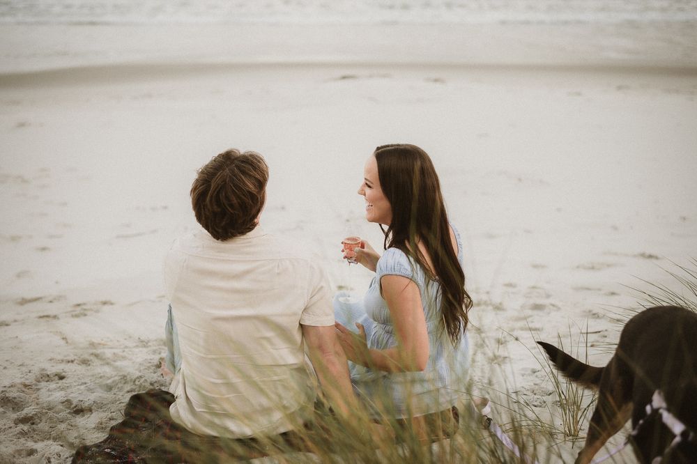 Couples session with their dog at Big Roaring Beach in Southern Tasmania, captured by elopement and family photographer Joss Jensen