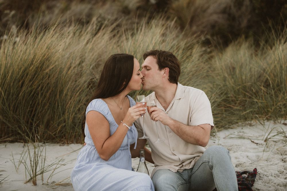 Couples session with their dog at Big Roaring Beach in Southern Tasmania, captured by elopement and family photographer Joss Jensen