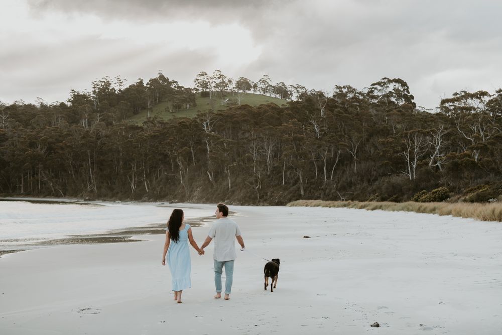 Couples session with their dog at Big Roaring Beach in Southern Tasmania, captured by elopement and family photographer Joss Jensen
