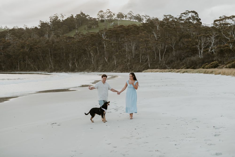 Couples session with their dog at Big Roaring Beach in Southern Tasmania, captured by elopement and family photographer Joss Jensen