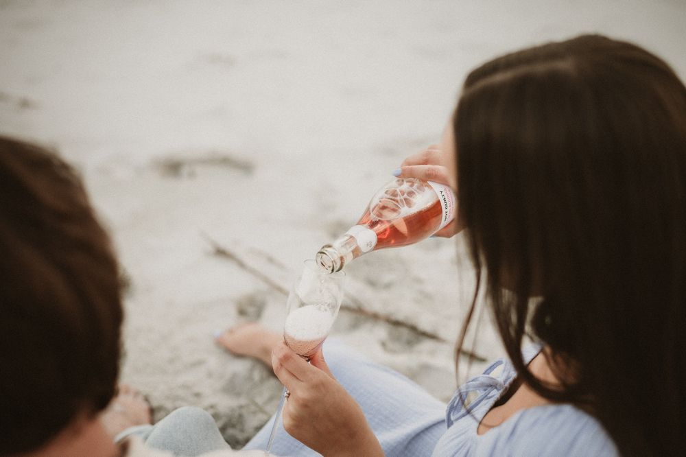 Couples session with their dog at Big Roaring Beach in Southern Tasmania, captured by elopement and family photographer Joss Jensen