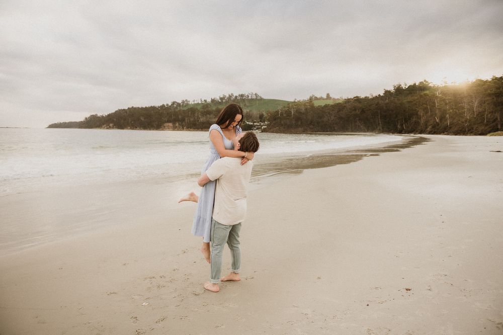 Couples session with their dog at Big Roaring Beach in Southern Tasmania, captured by elopement and family photographer Joss Jensen