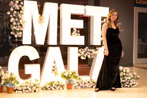 Large illuminated letter decorations with floral arrangements at event venue.