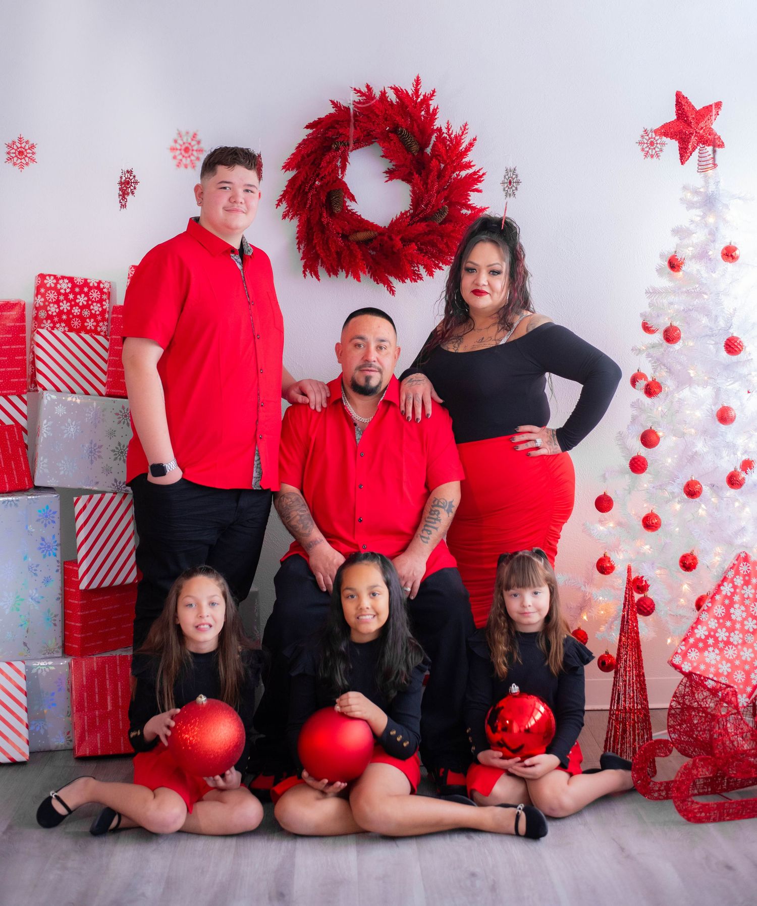 Holiday family photos with red and black theme against white Christmas backdrop.
