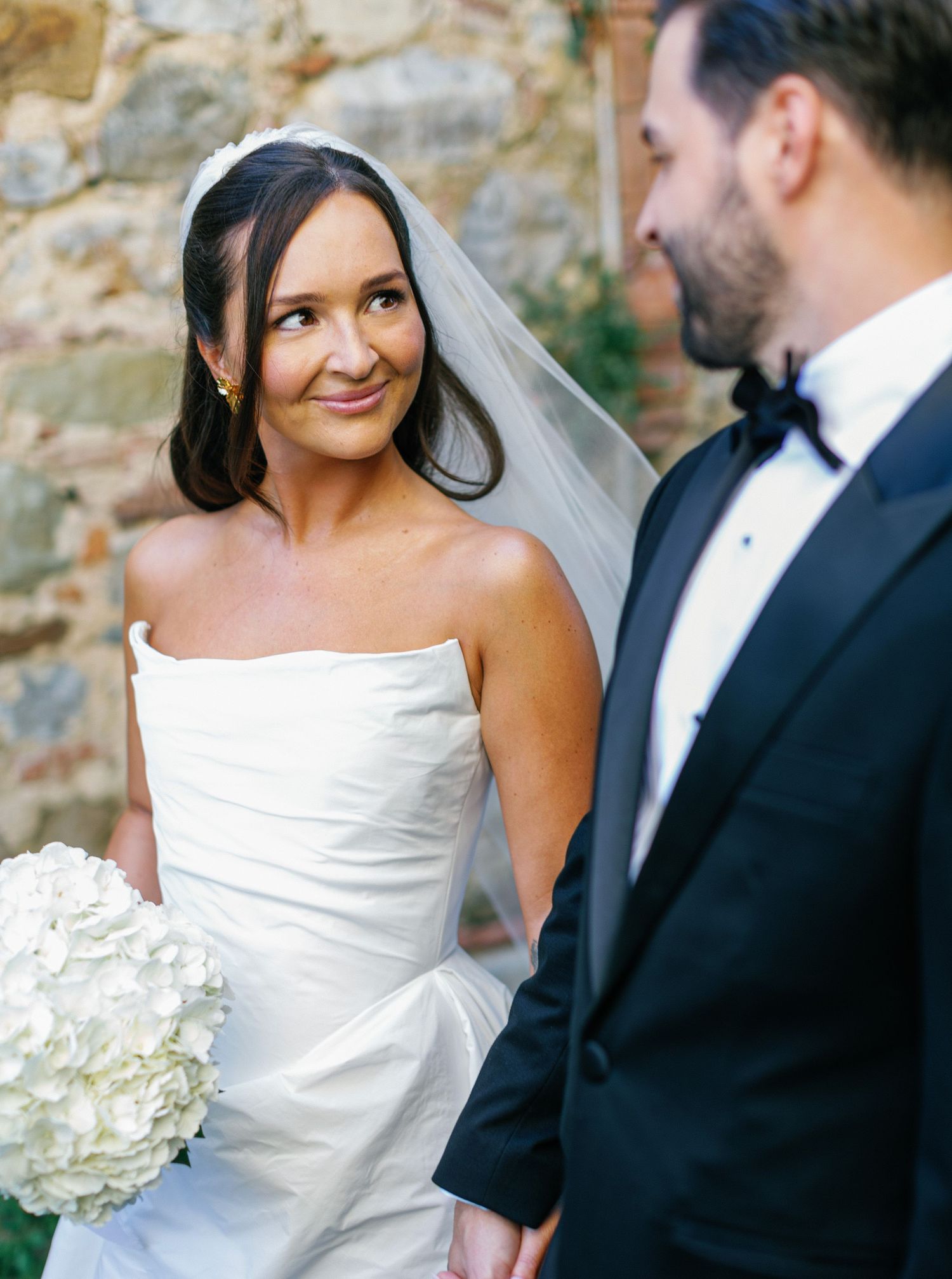 A romantic wedding moment captured in a series of candid shots showing a couple in formal attire with white hydrangea bouquet.