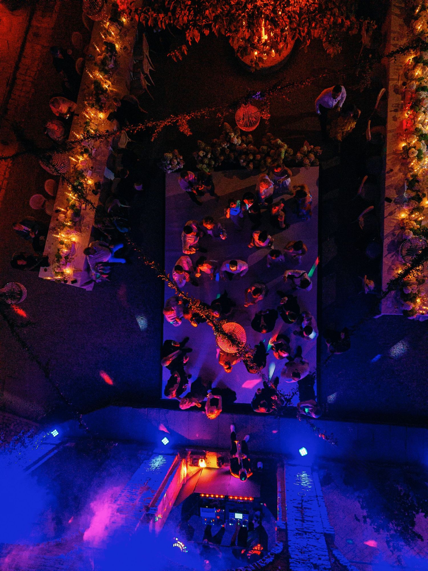Nightclub scene illuminated with vibrant blue and red lighting creating a dynamic party atmosphere.