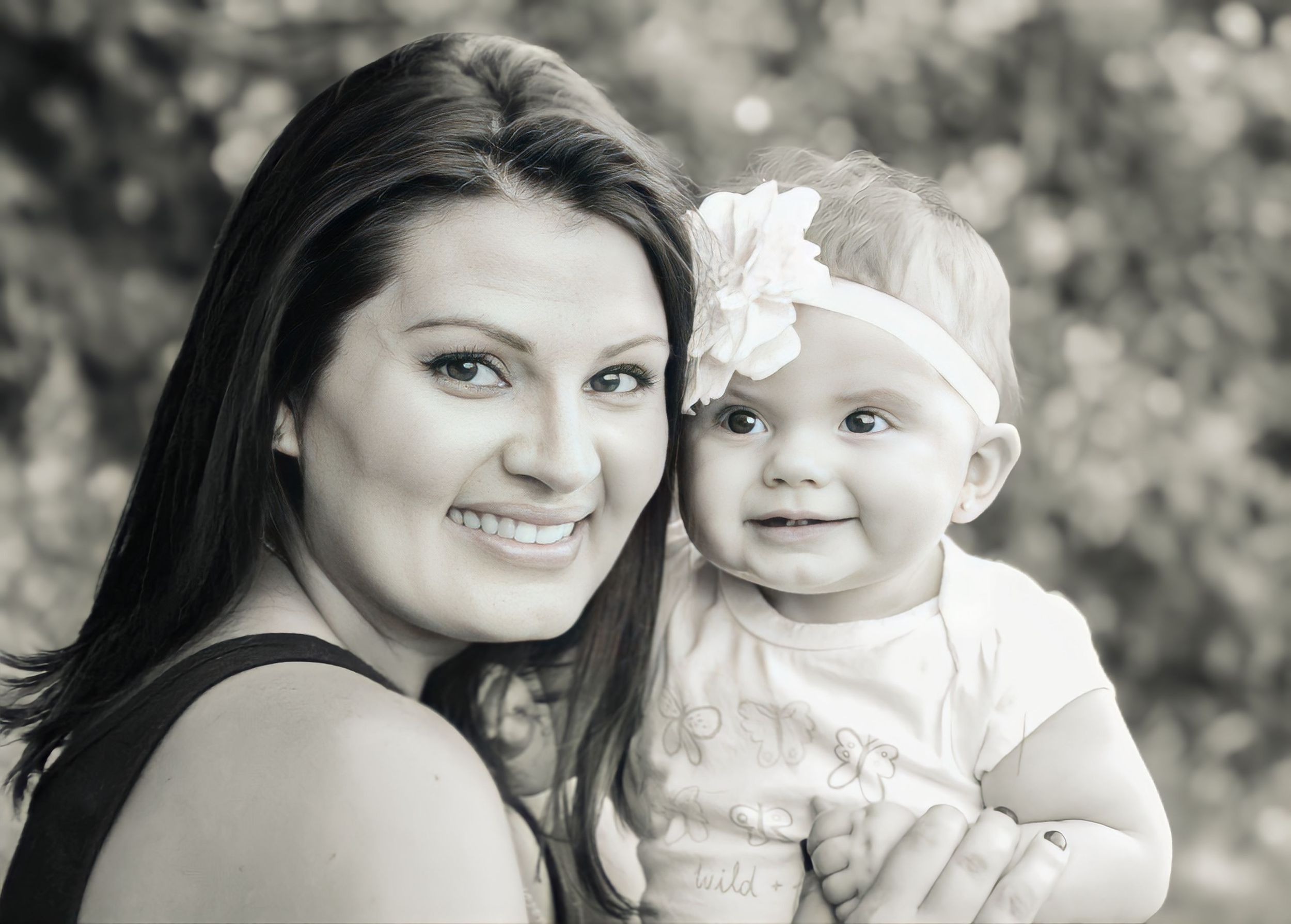 Joy filled black & white portrait of a mom and her baby with a white headband smiling outdoors. Wine Country - Napa, CA