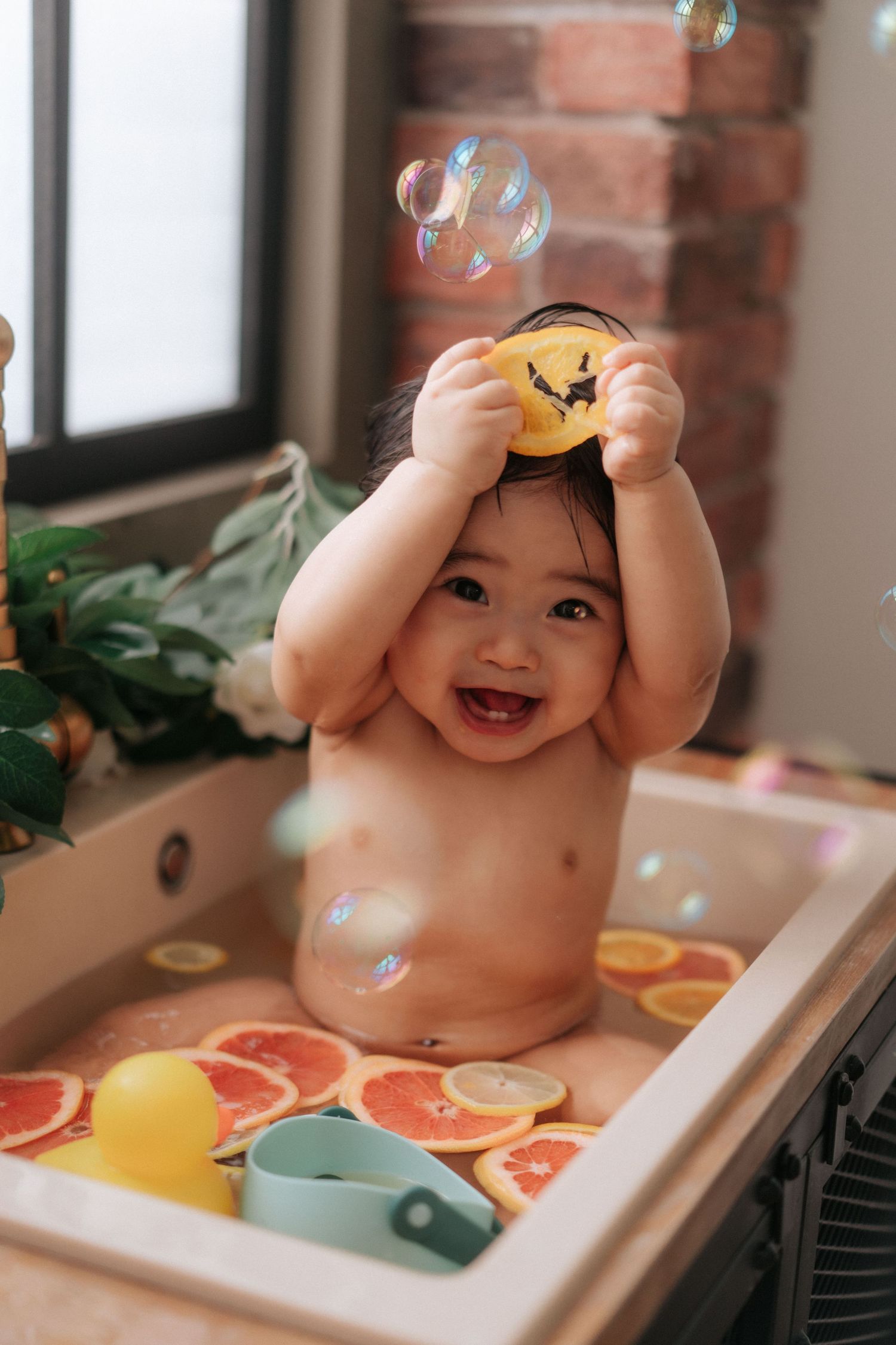 Series of cake smash photos with white dress, teddy bears, balloons and orange backdrop for baby milestone celebration.