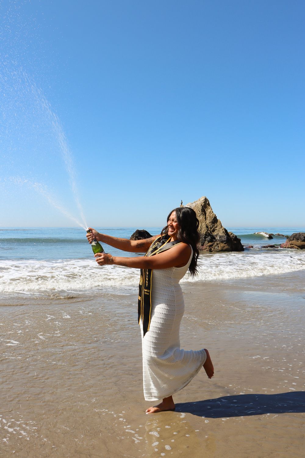 A sequence of four photos shows a person in a white dress striking graceful dance poses on a sunny beach with ocean waves.