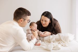 mum and dad looking at baby during lifestyle newborn session in the bishopdale studio