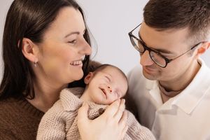 Mum holding baby during newborn session in bishopdale studio