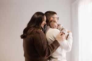 Family newborn session in the studio, dad holding their baby