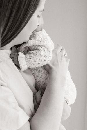 Mum holding her daughter during newborn session in studio, bishopdale