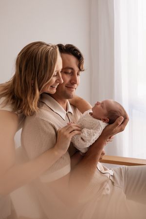 First time parents admiring their baby during studio newborn session in Bishopdale