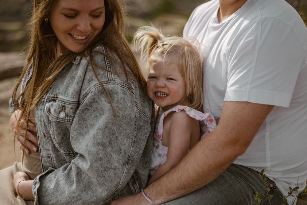 Intimate family moments shared during sunset photoshoot outdoors.