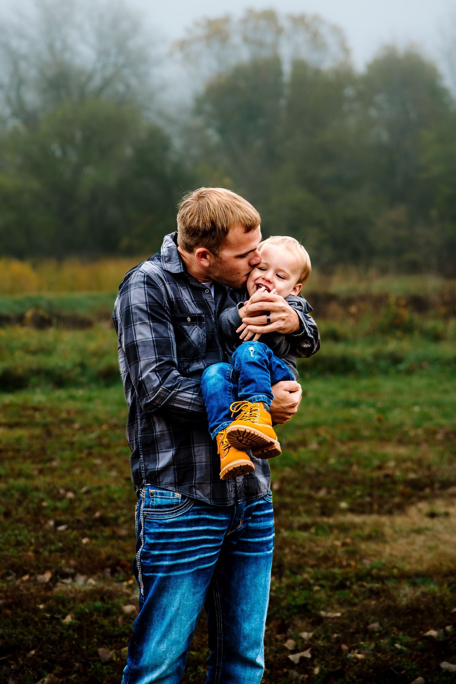 A heartwarming sequence of tender moments between parent and child playing together in a misty autumn field.