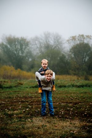 A sequence of photos shows someone bending down to pick something up in a misty autumn field.