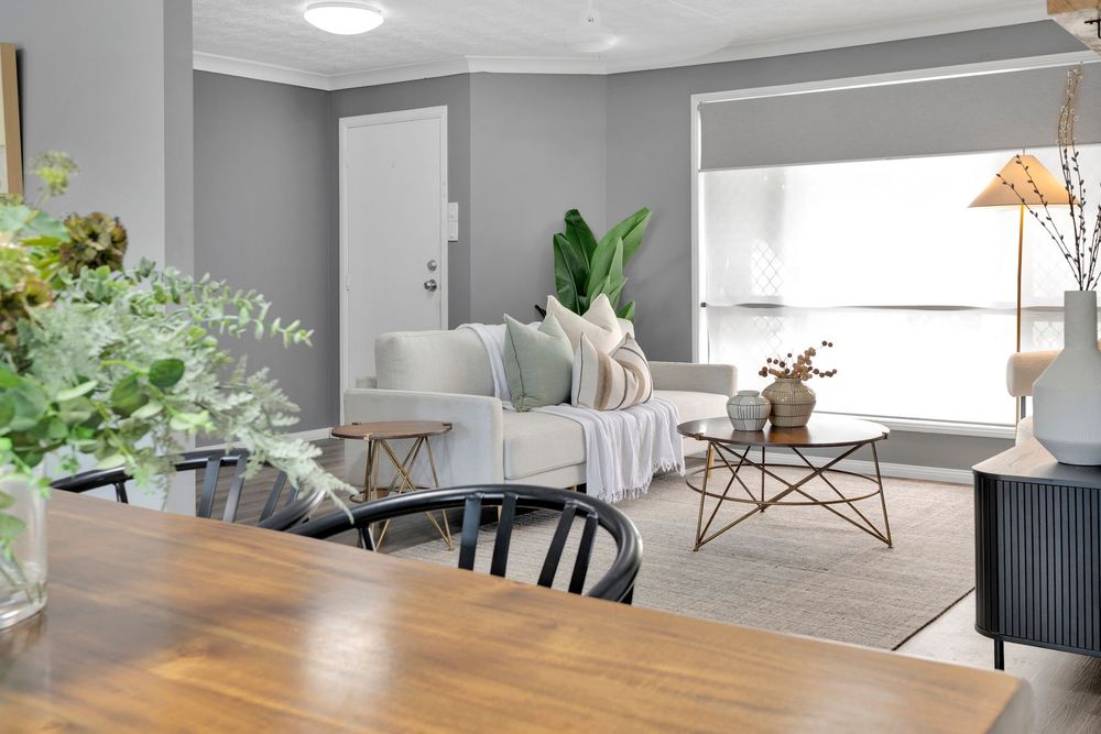 Modern Scandinavian living room interior with white walls, wood floors and minimalist decor in natural tones.