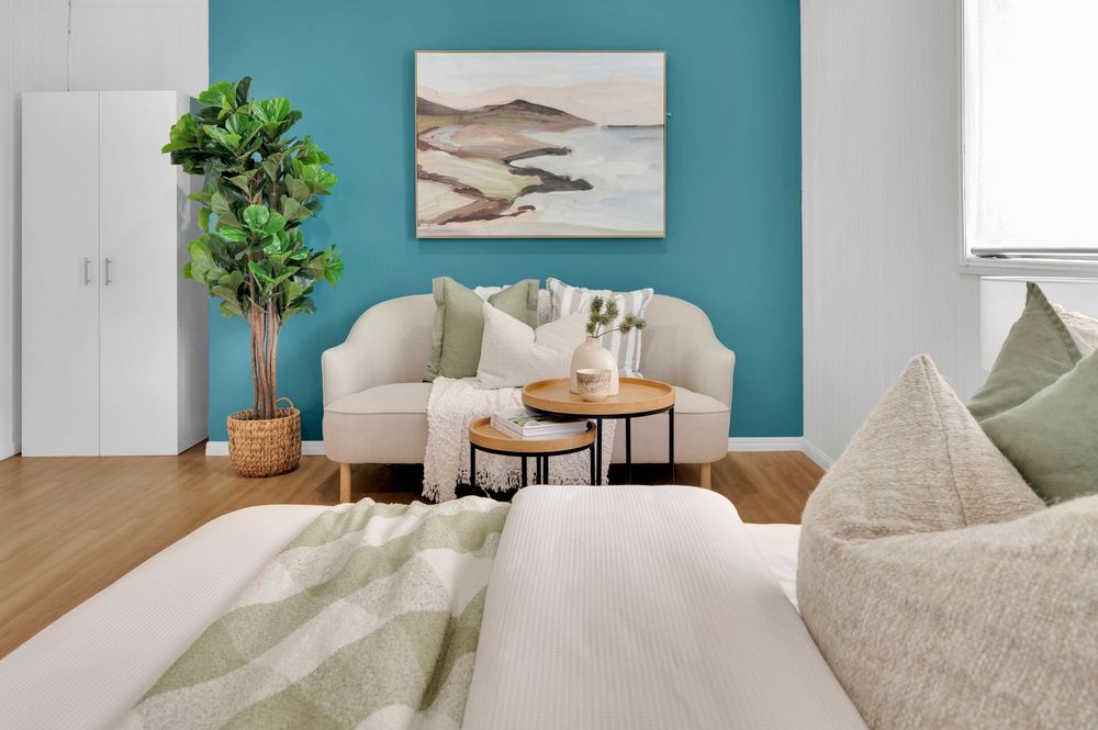 A series of interior design photos showing modern rooms with teal accent walls and minimalist decor.