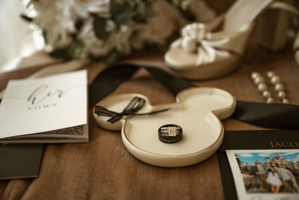 Wedding day details including rings, invitations, and accessories arranged artistically.