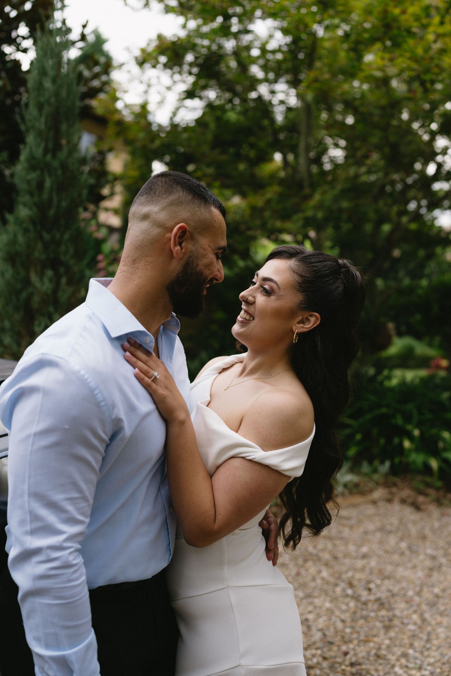 A romantic moment captured outdoors with a couple in an intimate embrace.