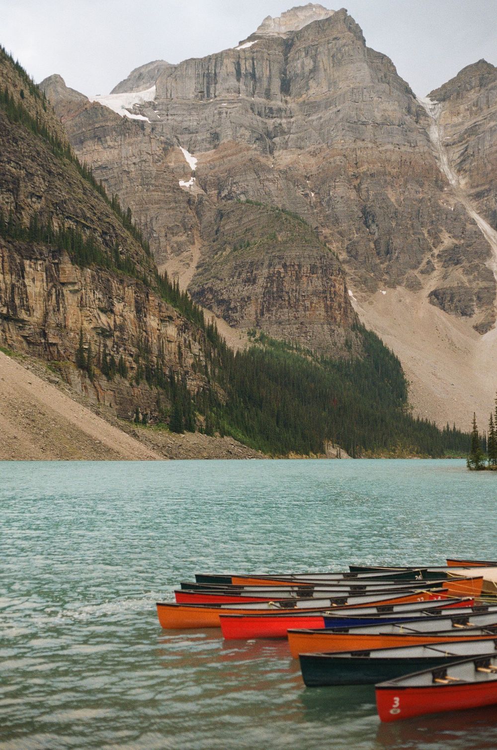 Canoes tied up on Moraine Lake in Banff Canada on film