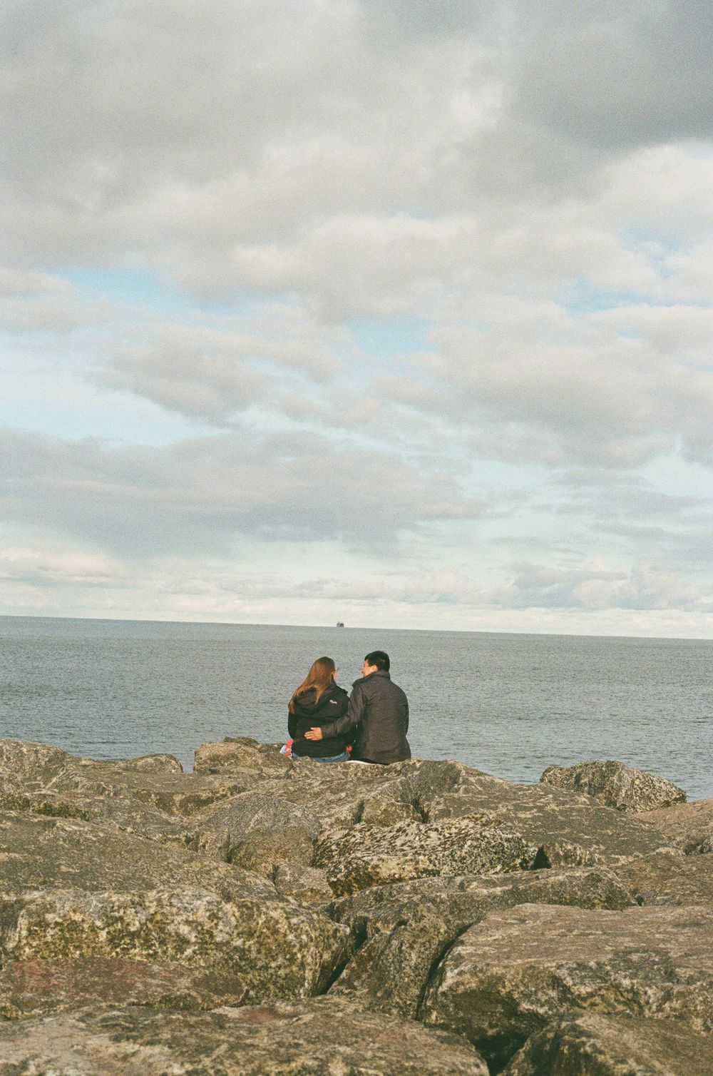 A couple watching as a shipping vessel comes into port in Duluth Minnesota, shot on film