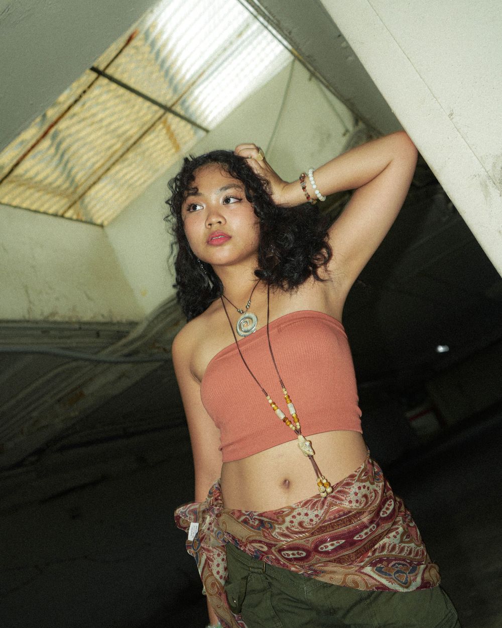 Fashion photography in an industrial space featuring urban streetwear styling.