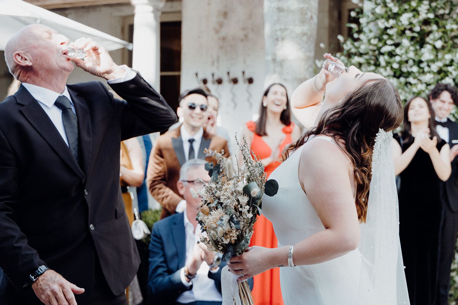 The bride and her father drink a shot of alcohol before the ceremony, captured by Apertured Media Auckland Wedding Photographer.