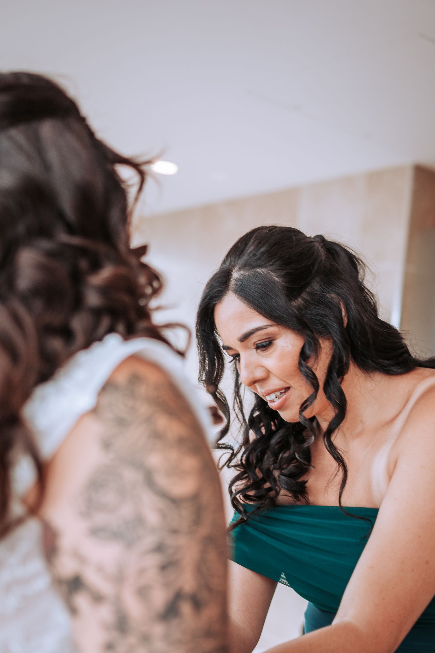Two people share an intimate moment during wedding preparations.