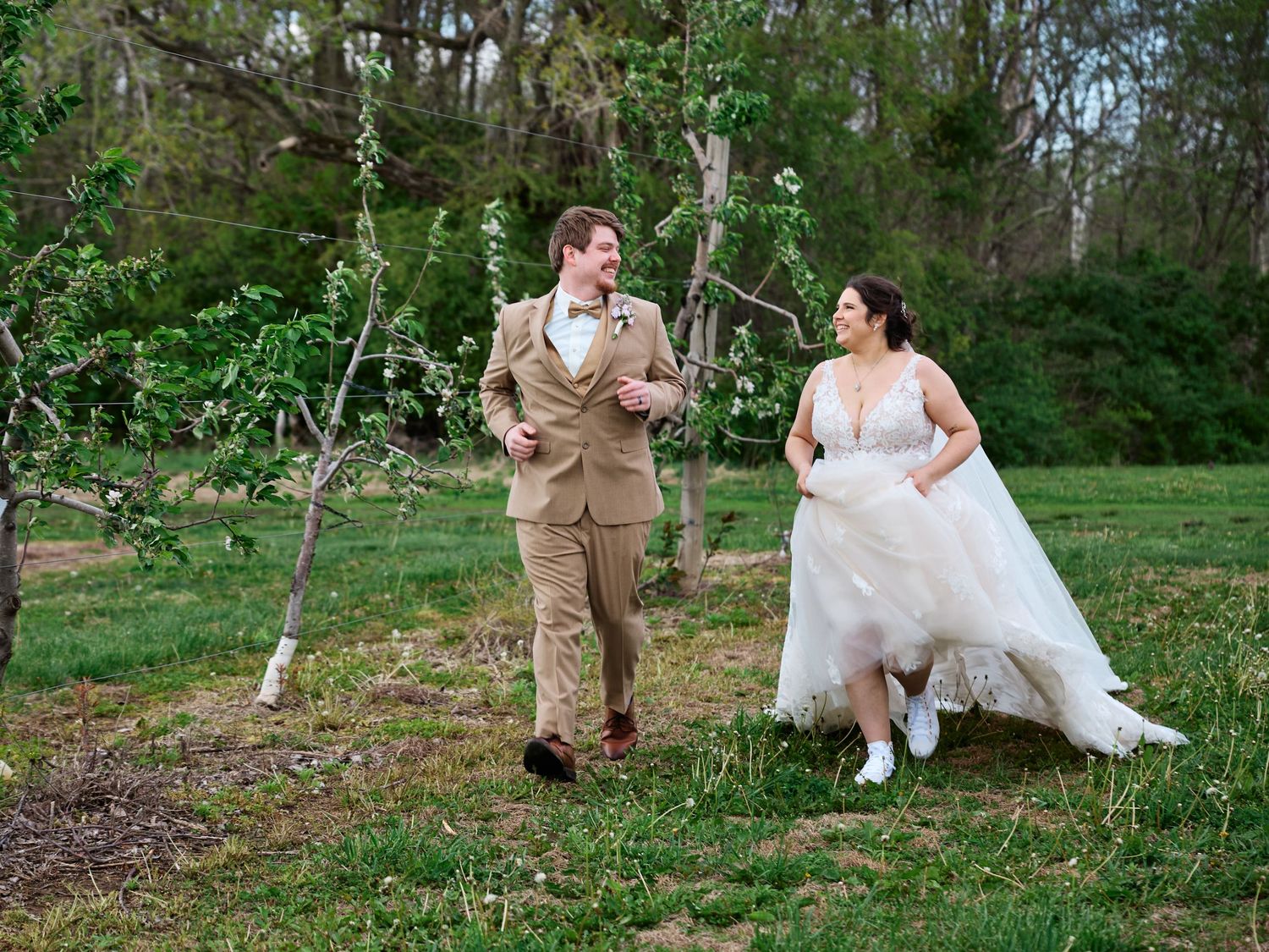 A bride and groom share an intimate moment together in a church pew with stained glass windows in the background.
