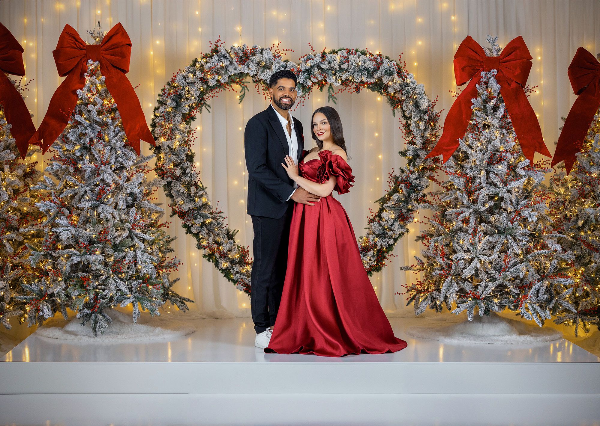 Elegant holiday scene with flocked Christmas trees and white twinkle lights creating a romantic atmosphere.