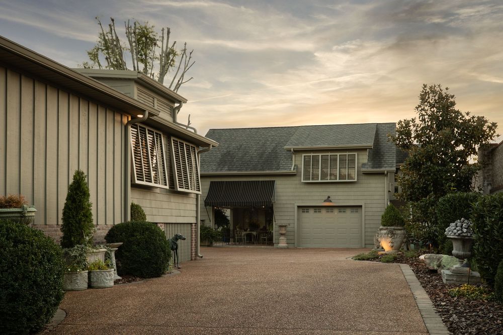 Soft sunset lighting of the exterior of a home, showcasing landscaping around the property.