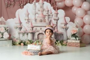 Princess themed birthday setup with pink balloons and castle backdrop creates magical atmosphere.