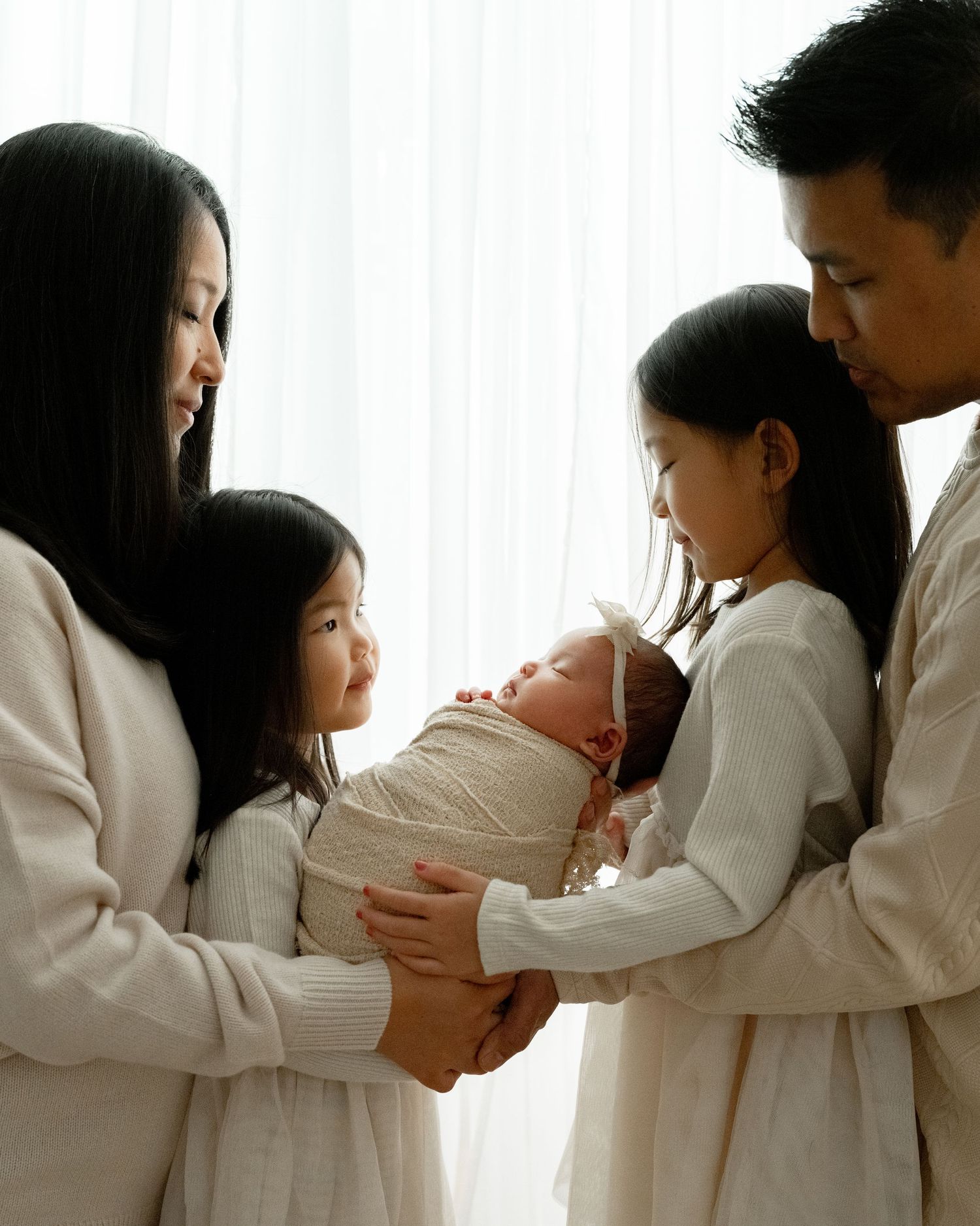 A series of intimate moments captured in white clothing against a bright background, showing gentle embraces and connections.