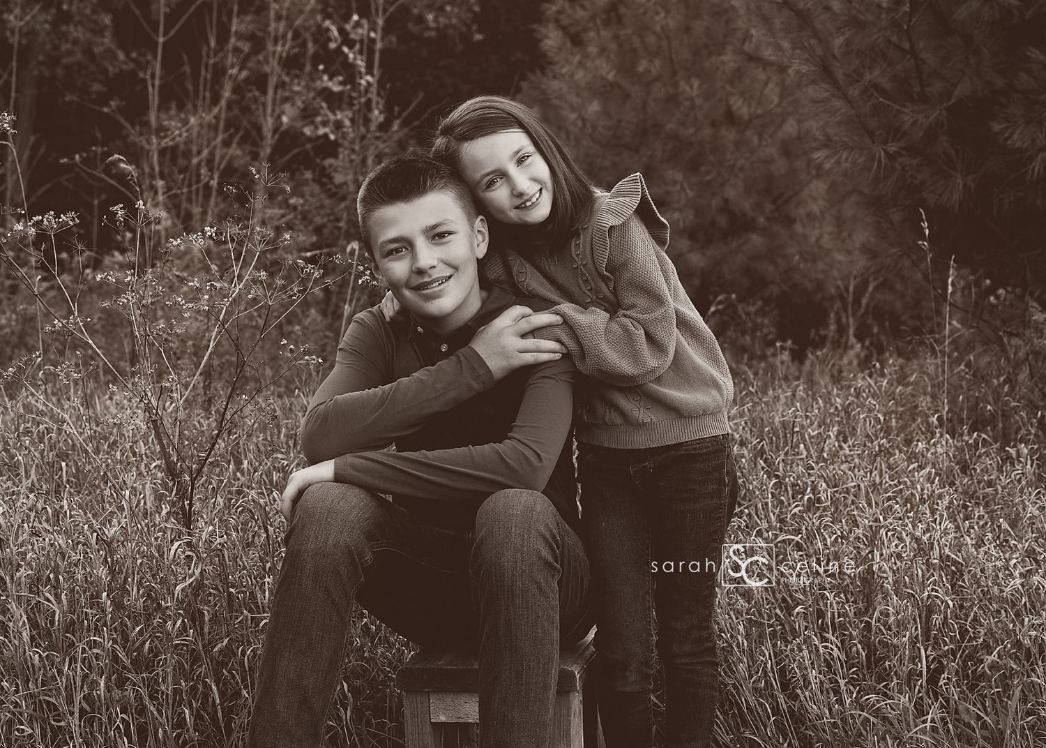 A series of black and white romantic photos showing tender moments between a couple in a natural outdoor setting.