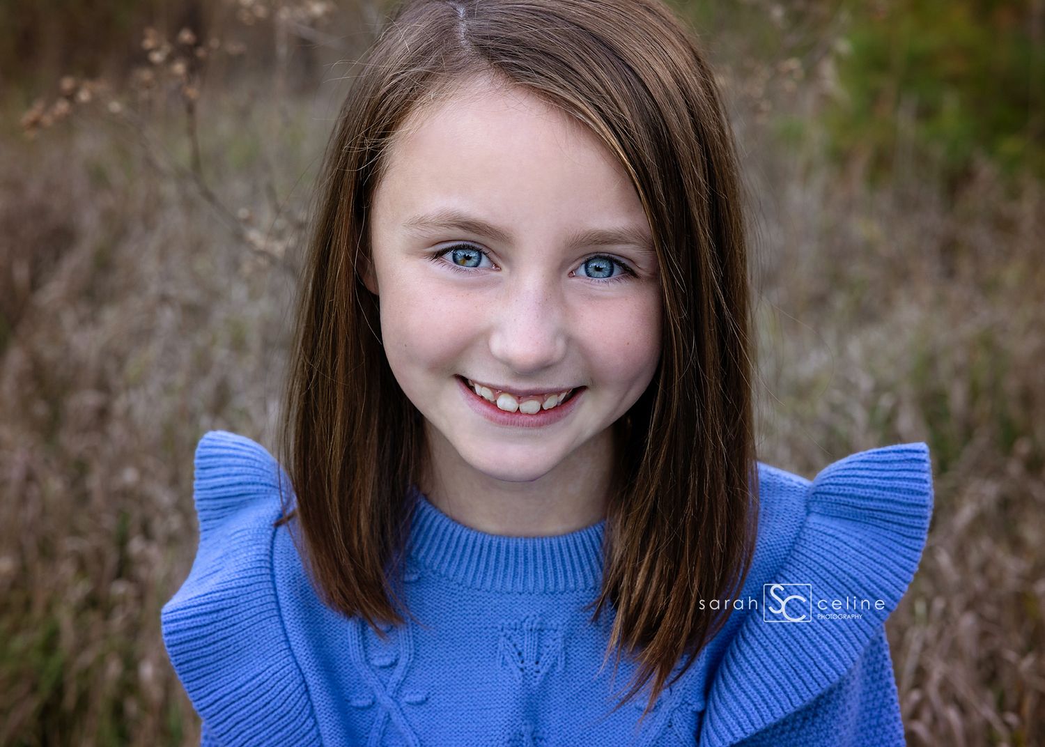 A sequence of five portraits showing a young person in a blue ruffled top against a blurred natural background.