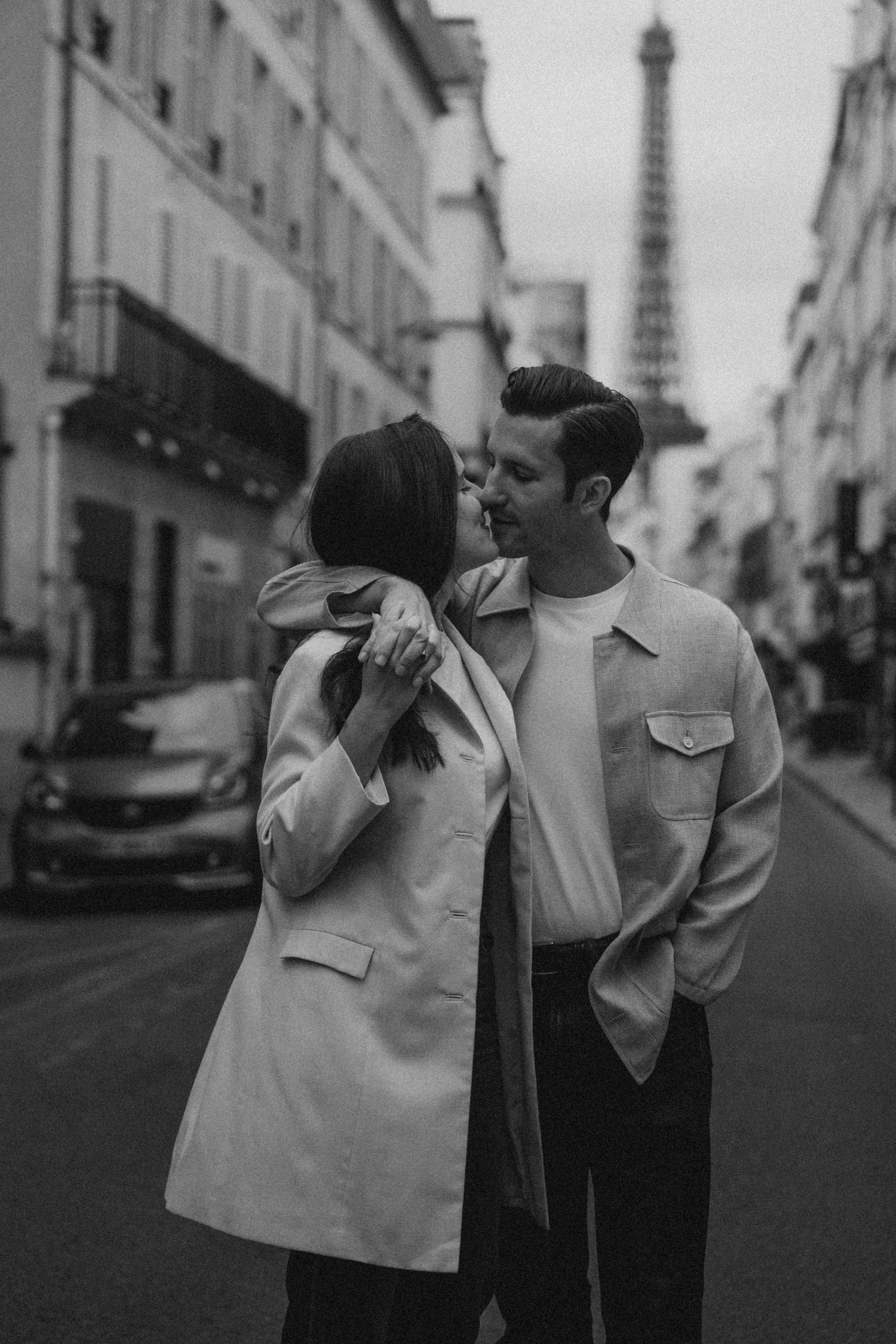 Romantic couple session in Paris featuring the Eiffel Tower, highlighting love, connection, and candid moments.