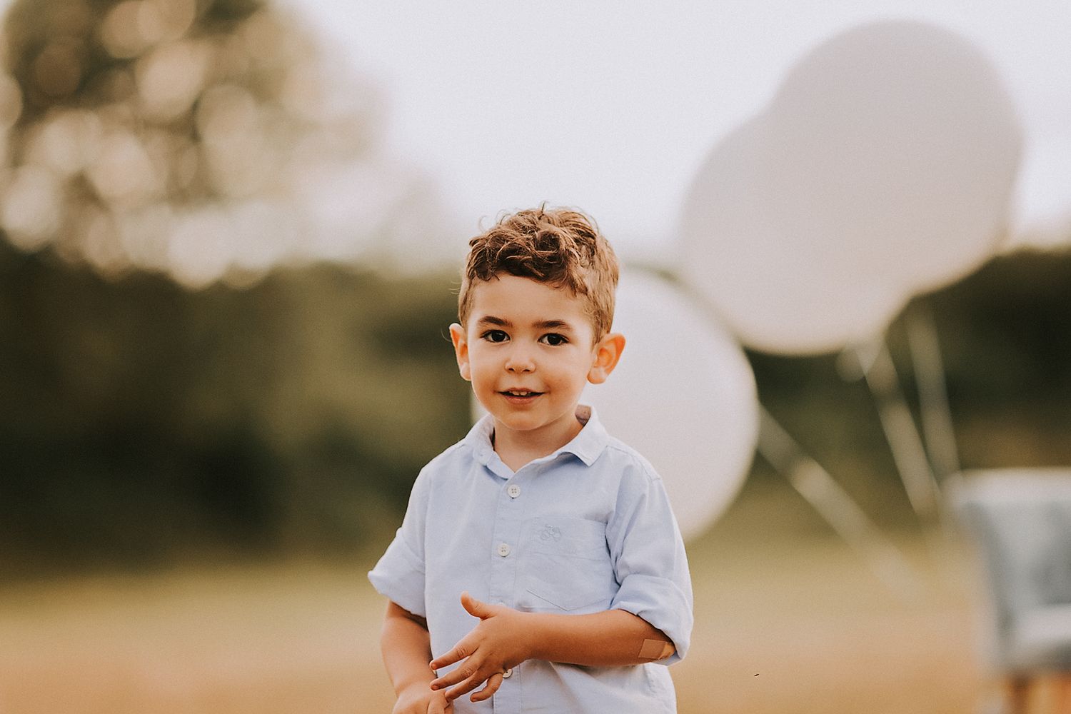 A collection of seven outdoor portrait photographs arranged in a horizontal row shows a young child in casual attire.