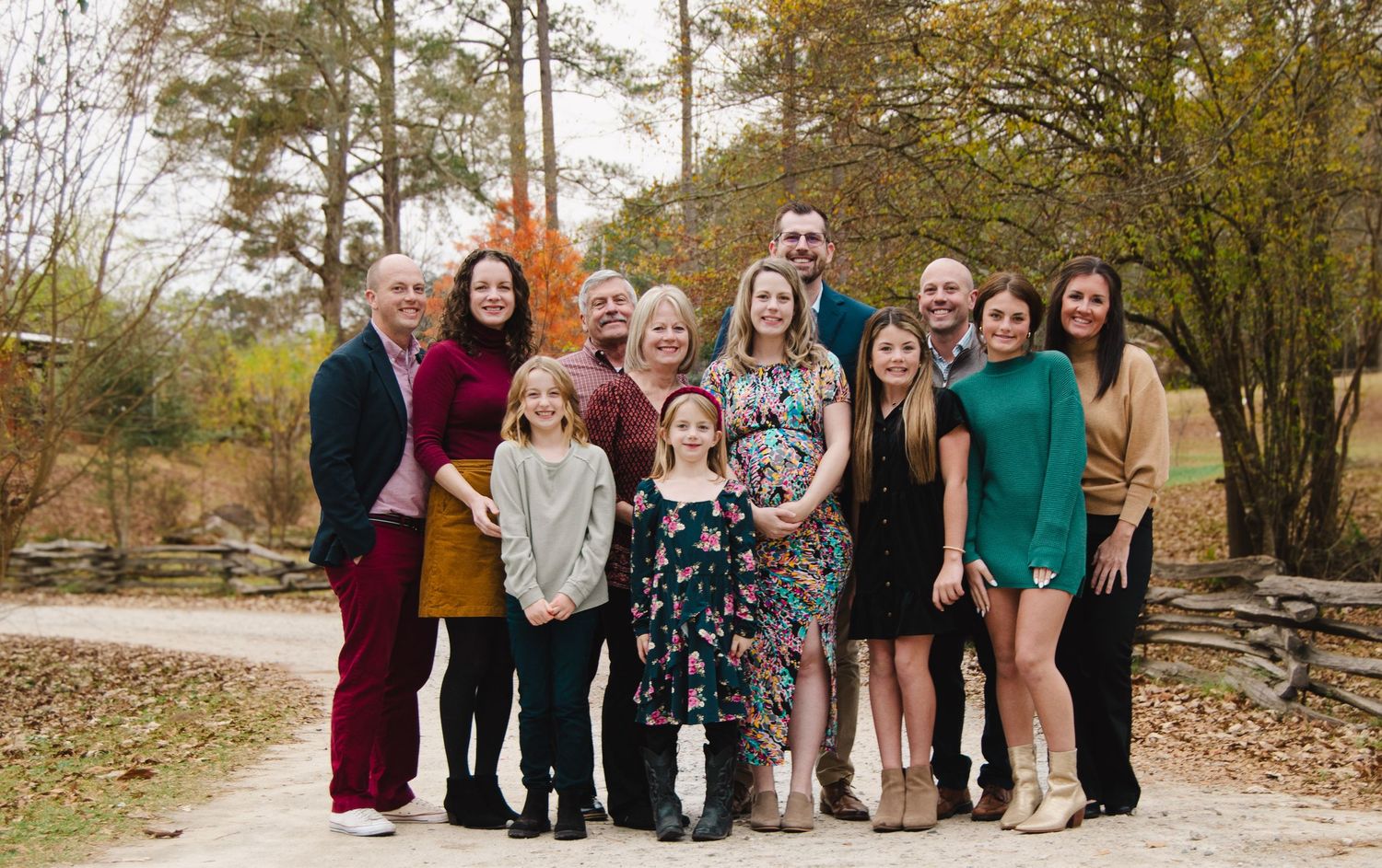 Large group photo of family and friends gathered outdoors in casual attire.