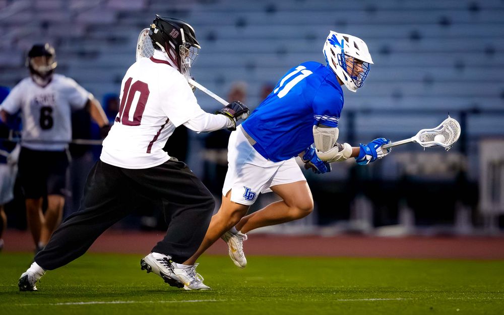 Lower Dauphin lacrosse player drives past the goalie during the 2026 Mid Penn Championship at Landis Field by SportsFox Photography, Hershey