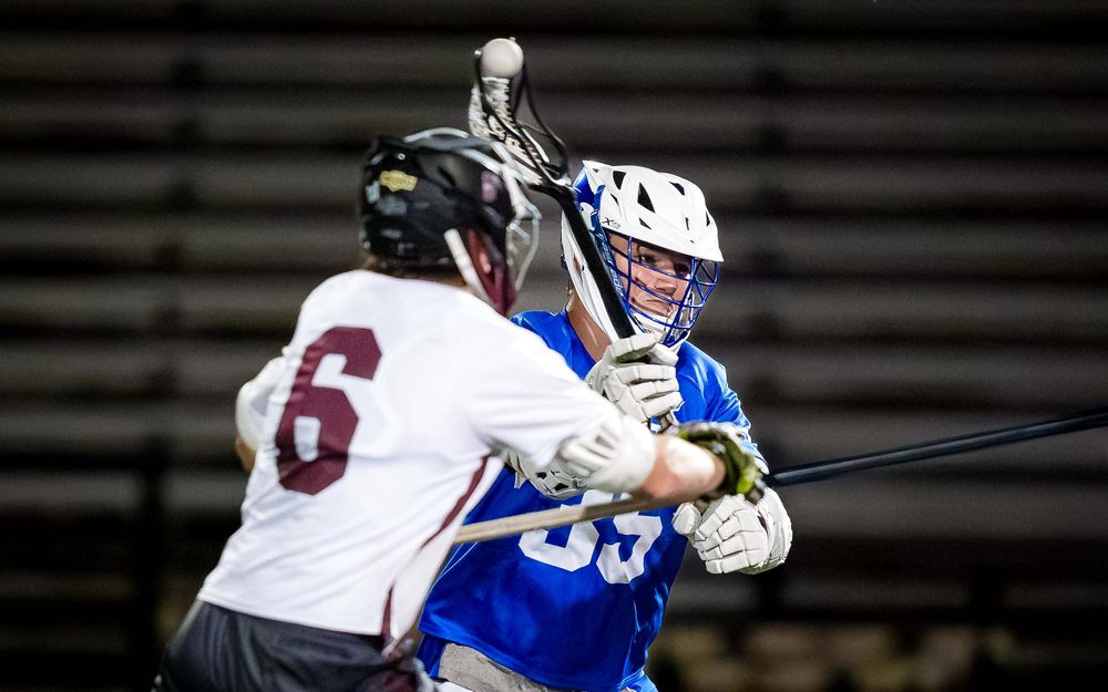 Lower Dauphin lacrosse player battles an opponent for possession during the 2026 Mid Penn Championship by SportsFox Photography, Hershey PA.