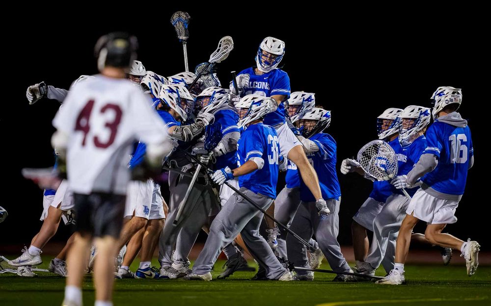 Lower Dauphin lacrosse team rushing the field after winning the 2026 Mid Penn Championship by SportsFox Photography, Hershey PA.